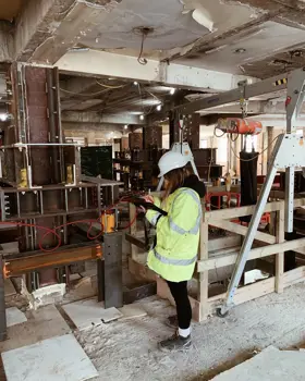 Brogan MacDonald, Head of Sustainability in Building Structures at Ramboll, carrying out an inspection on a building site.