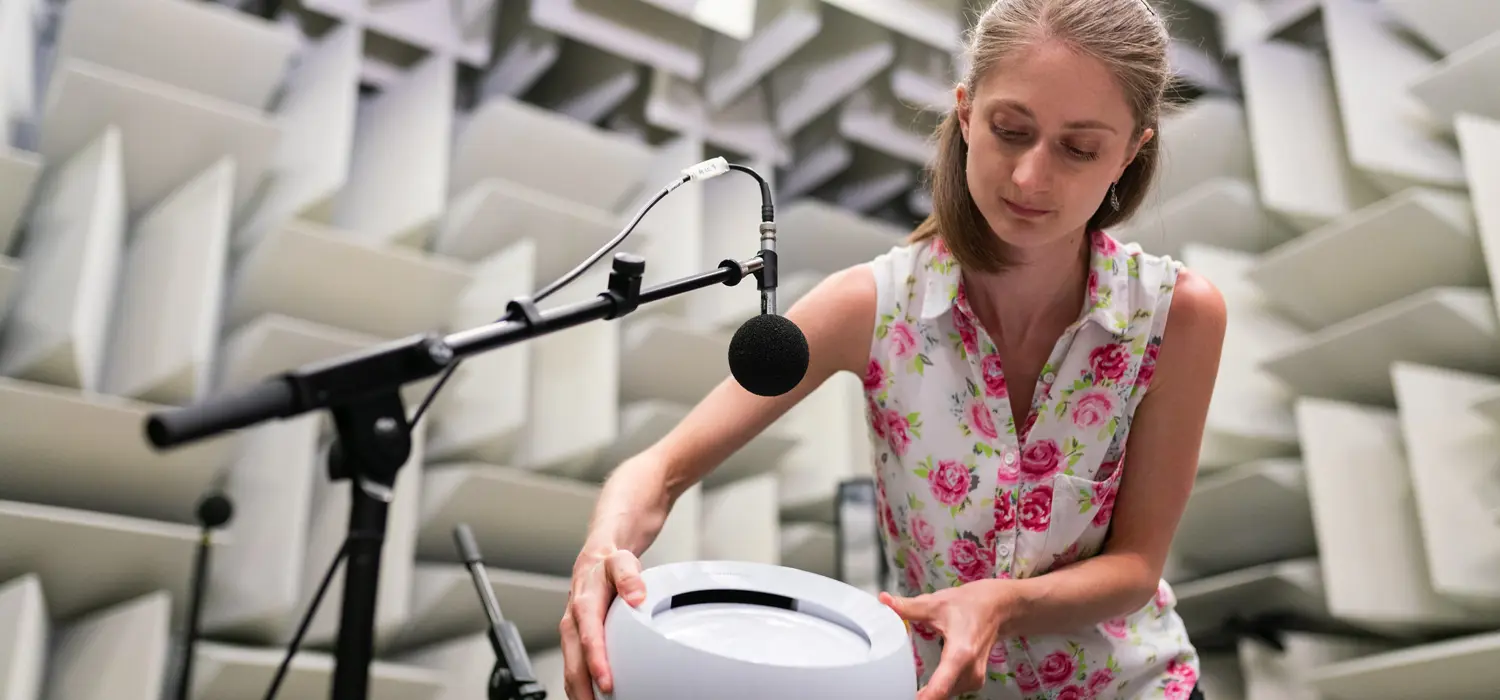 Female noise and vibration engineer test products in anechoic chamber