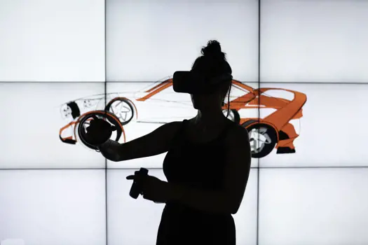 Silhouetted female design engineer wears virtual reality headset to sketch in 3D