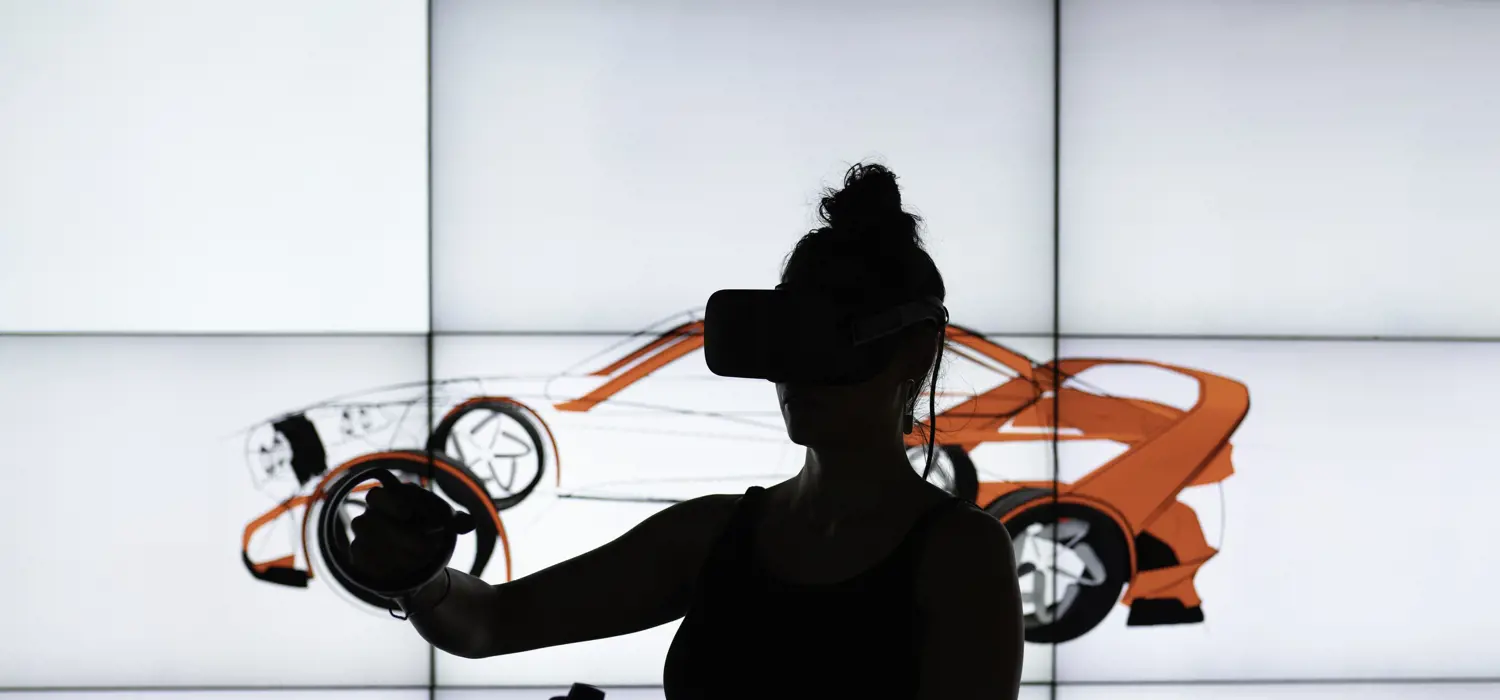 Silhouetted female design engineer wears virtual reality headset to sketch in 3D