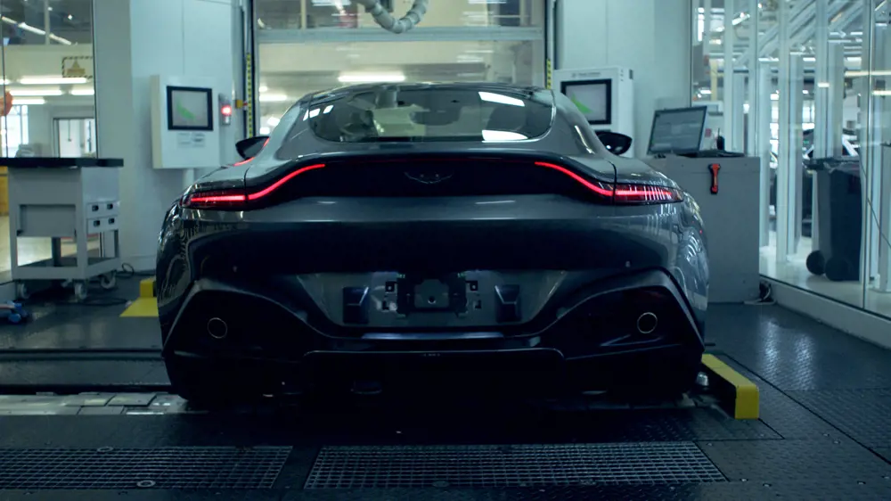 Back of a black Aston Martin car in testing facility