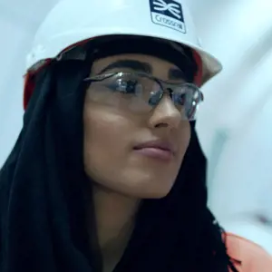 Female civil engineer, stands in well-lit underground tunnel