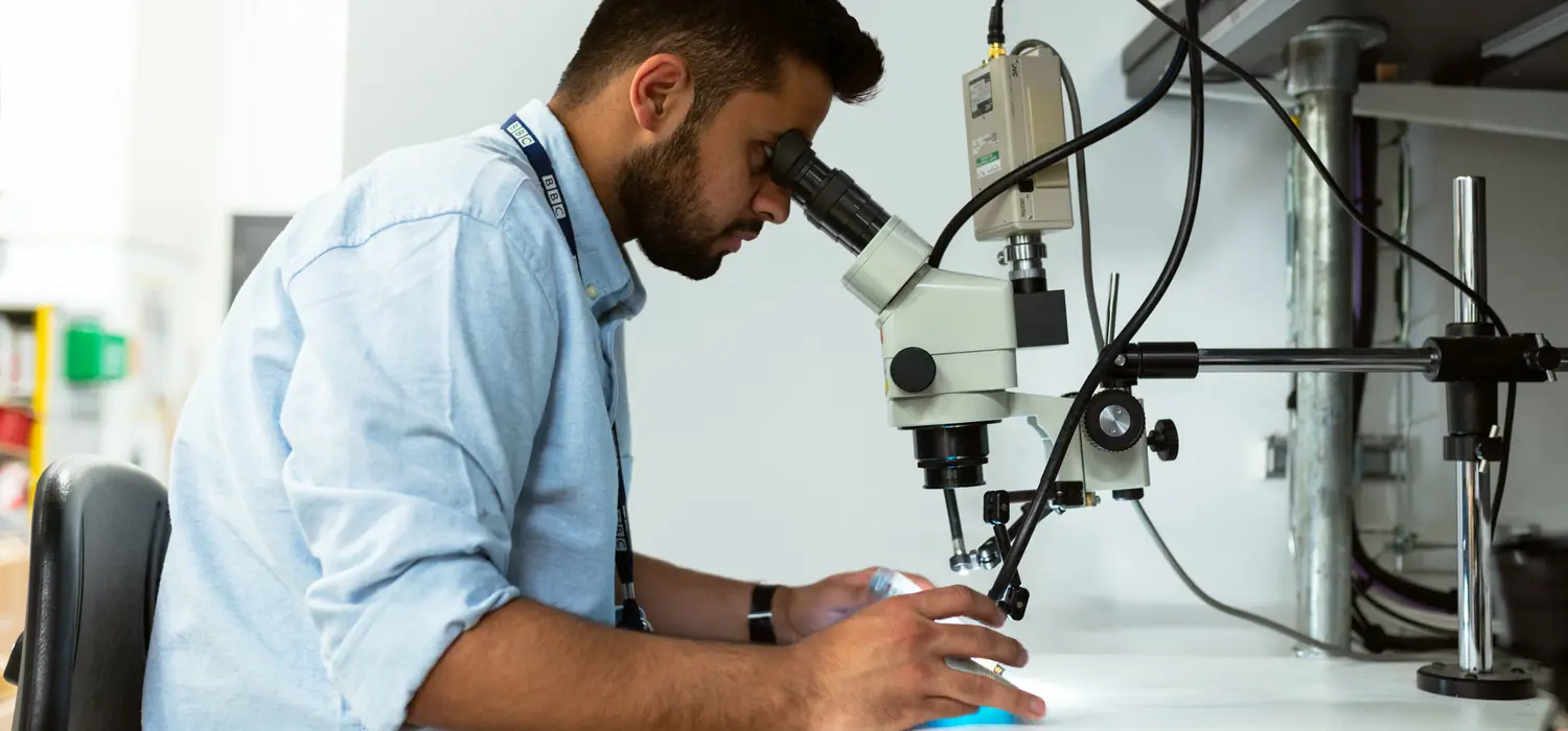 Engineer using a microscope.