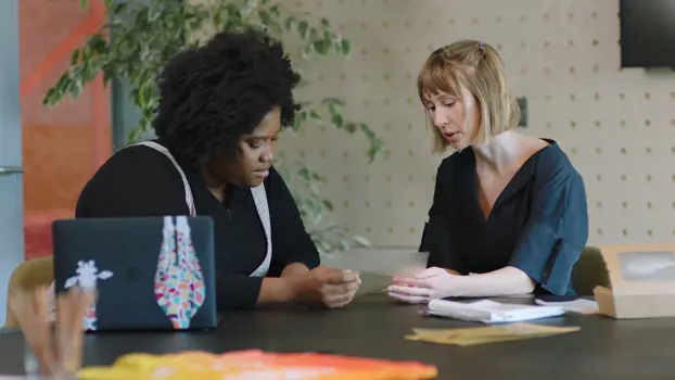  Female product designers discussing biodegradable plastic alternative 