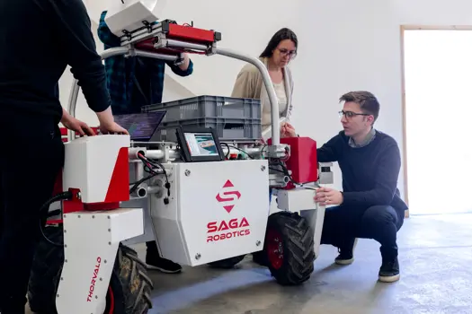 Mechanical engineers inspecting an agricultural robotic.
