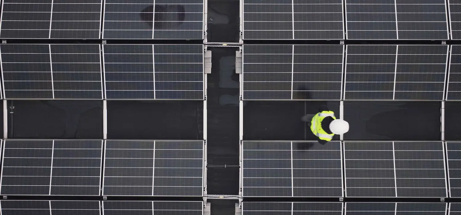 Apprentice engineer inspecting solar panels