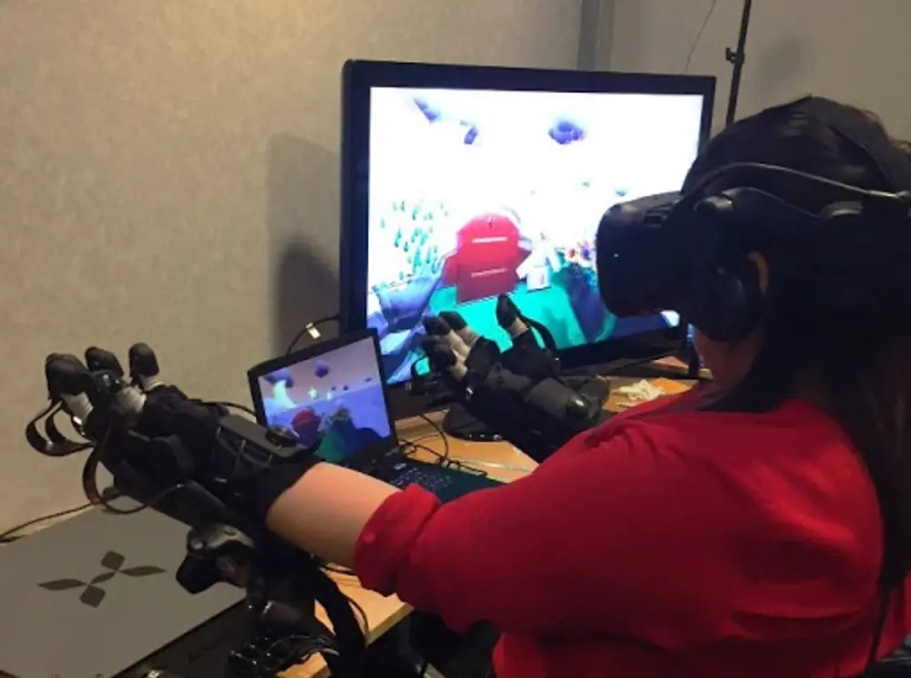 Human factors engineer testing haptic feedback gloves by Haptx.