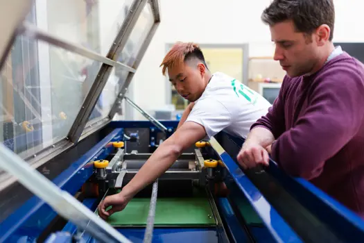 Male sports engineers conduct experiments on tennis equipment