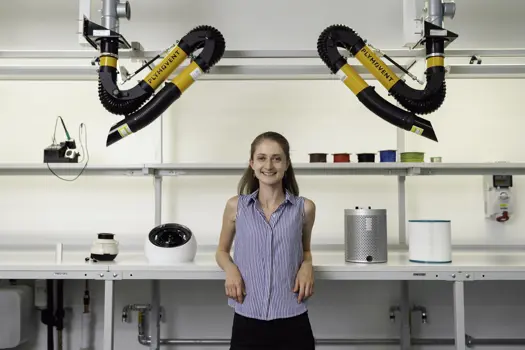 Female noise and acoustics engineer stands in workshop