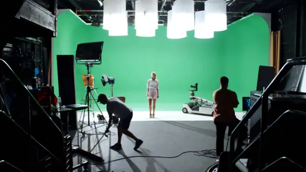 Female software engineer in front of green screen on film set