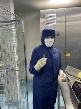 A team member at the Wockhardt factory holding the manufactured vial of the AstraZeneca COVID-19 vaccine.