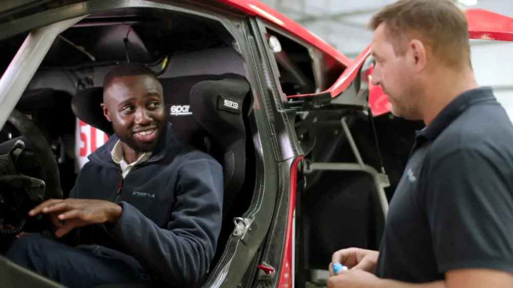 Mechanical engineer sitting in electric race car