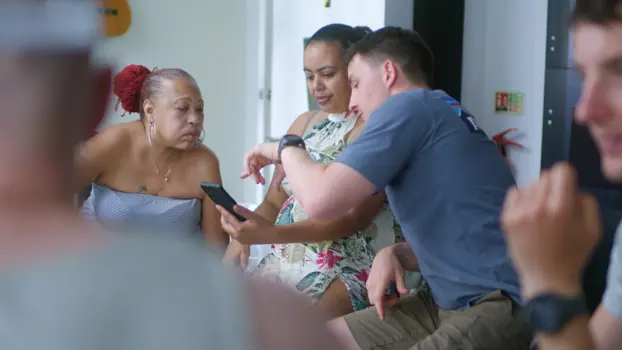 A brain injury rehabiliation support group looking at a mobile device